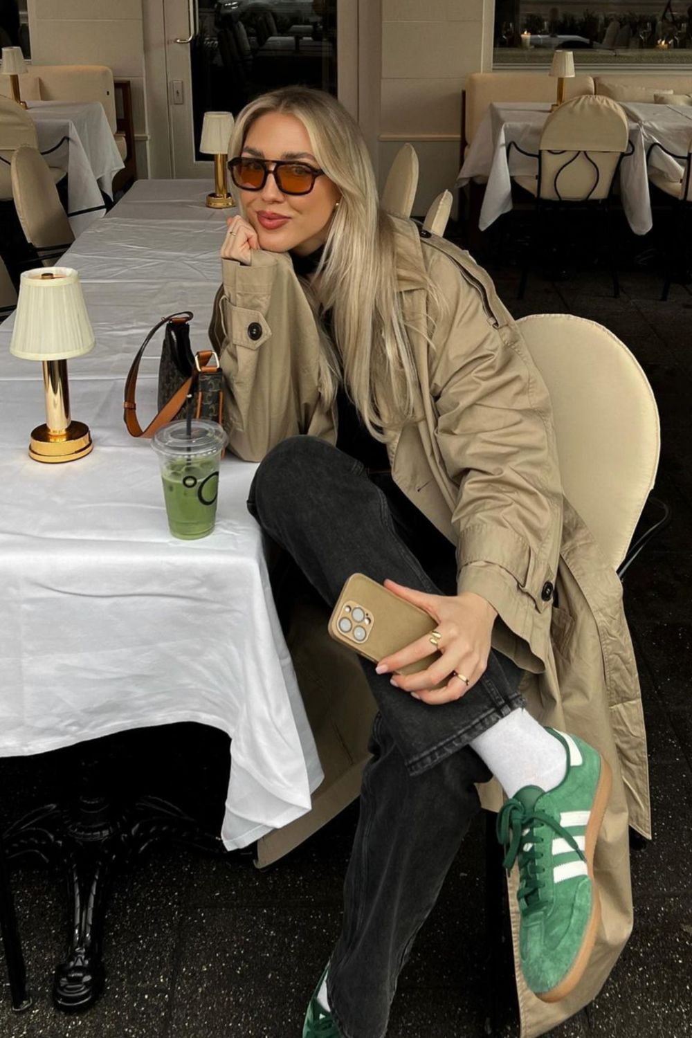 Earthy Layers and Easy Neutrals This outfit is a charming nod to fall tones and easy layering. A white mini skirt and oversized white tee set the base, topped with a warm brown jacket that adds just the right amount of structure. The green suede sneakers with gum soles pair beautifully with the earthy tones, while a white and green baseball cap brings the entire palette together. It’s laid-back, approachable, and ideal for those transitional weather days where comfort meets casual style.